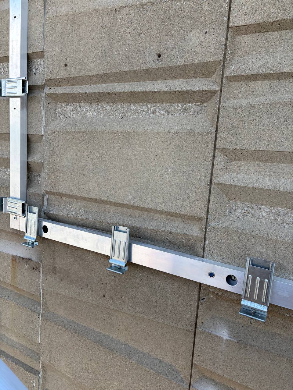 Détail du cadre et de ses fixations sur la façade
